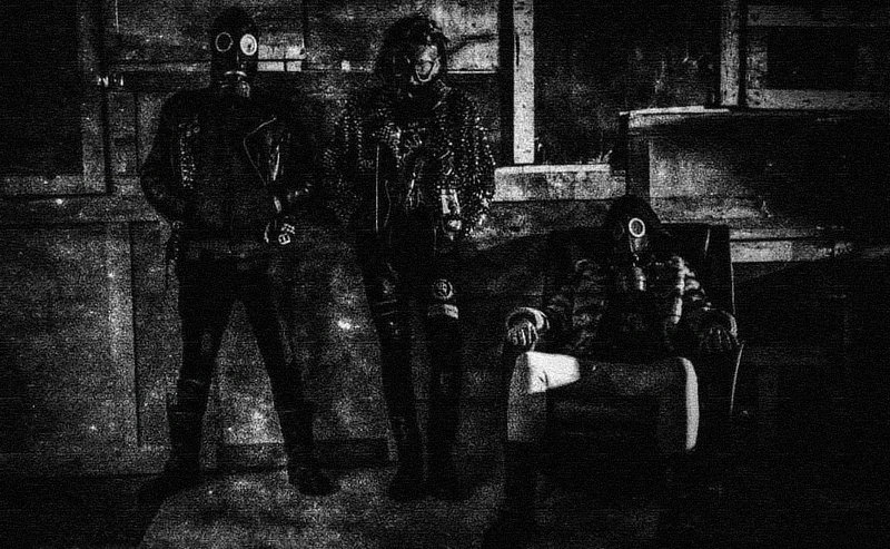 Band photo, all members wear gas masks