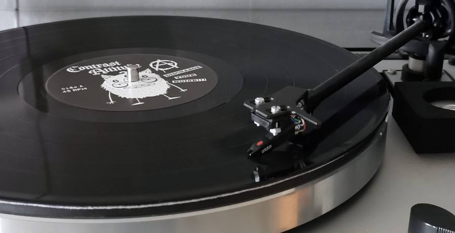 A photo of the vinyl record spinning on a turntable