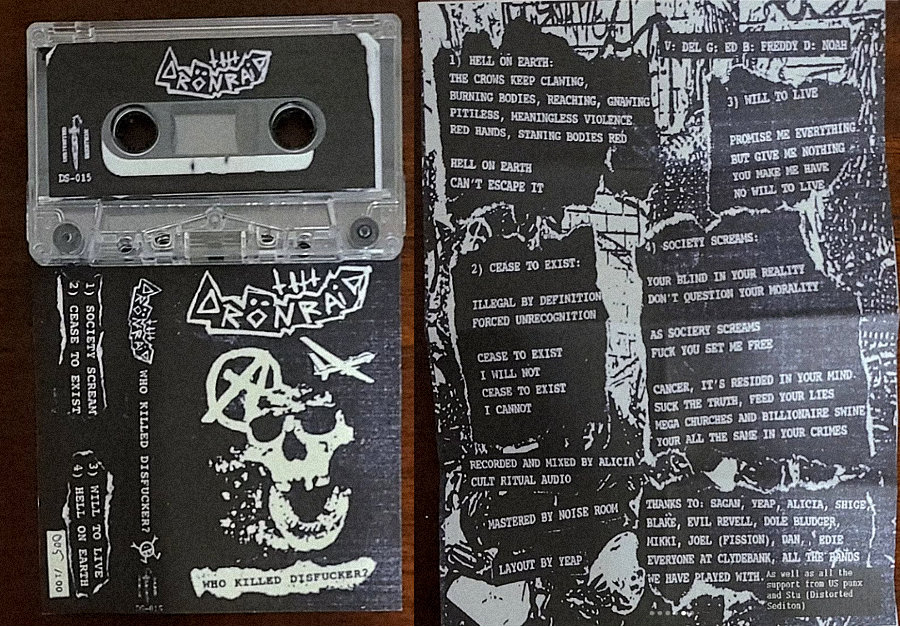Photo of the Distorted Sedition version of the tape, to the left we see the tape and the shell, to the right there's a photo of the unfolded j-card showing off the lyrics